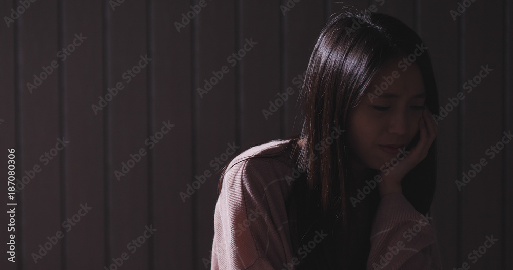 Fototapeta premium Woman crying in the dark