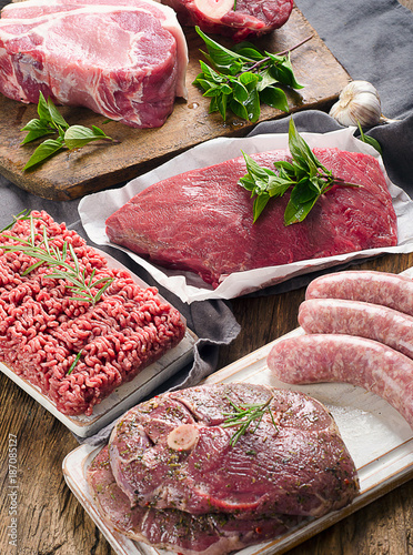 Obraz na płótnie Different types of fresh raw meat on dark wooden background.