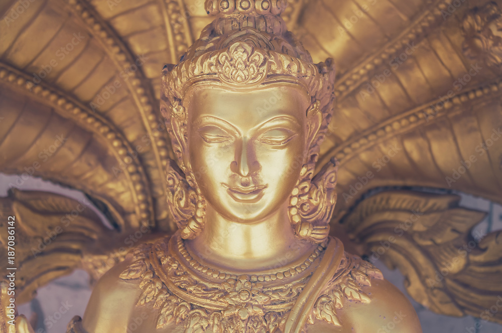 Close up of a golden buddha. Toned image with a vintage effect look.