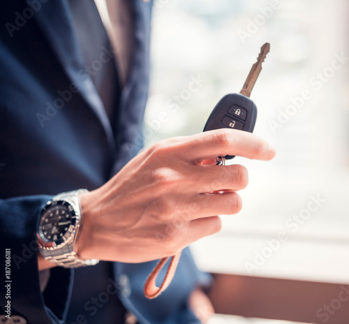 Businessman holding a car key