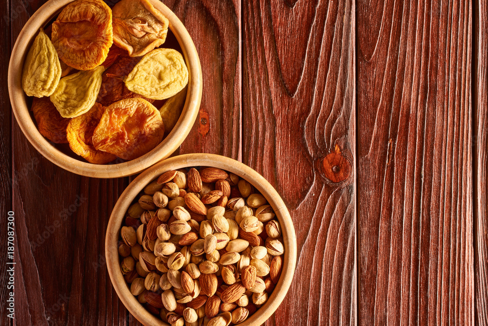 Dried fruits and nuts on wooden background Dried fruits and nuts on wooden background