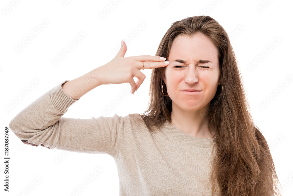 tired crazy woman with a gun gesture near the temple on a white background tired crazy woman with a gun gesture near the temple on a white background