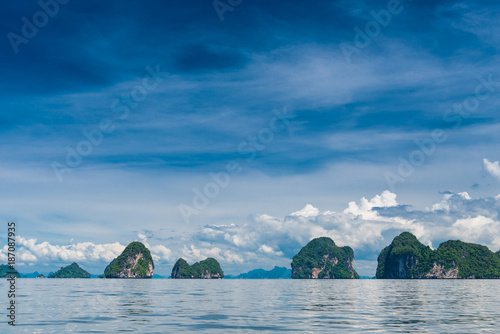 green rocks in a calm sea and beautiful clouds over the Andaman Sea  Thailand  views of Krabi