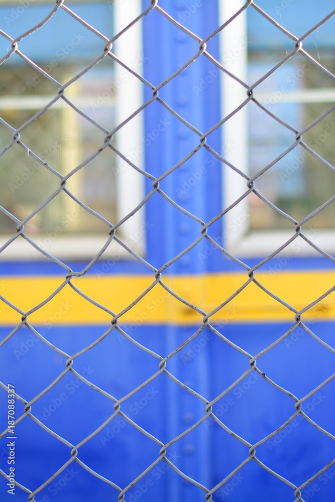 Fototapeta premium Mesh made of steel wire with window background vertical.