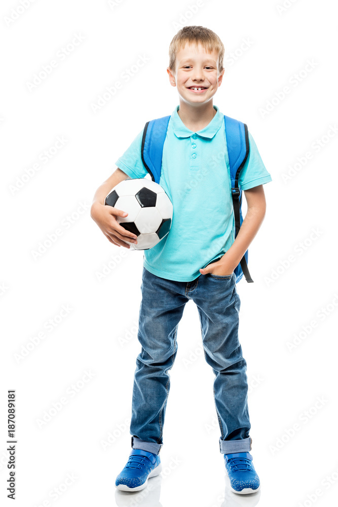 happy schoolboy holding a football ball isolated in full length on a white background happy schoolboy holding a football ball isolated in full length on a white background