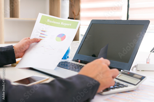 Business concept. Asian business man are reading business reports on paper and using a computer. Business working - manager works in the office with documents, office work.