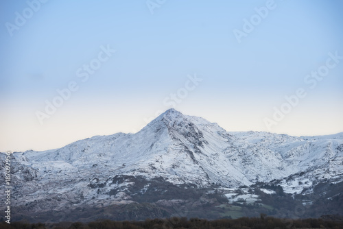 Beautiful Winter sunrise landscape image of Mount Snowdon and other peaks in Snowdonia National Park © veneratio