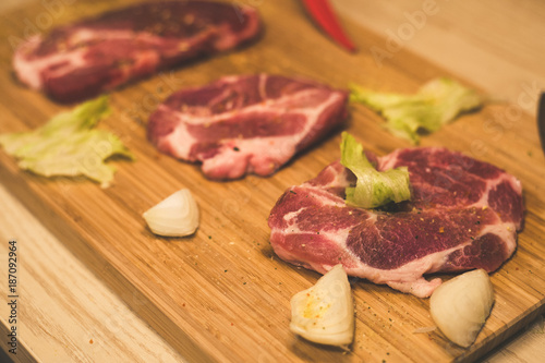 Raw spare ribs herbs spices on a wooden cutting board with knife. photo