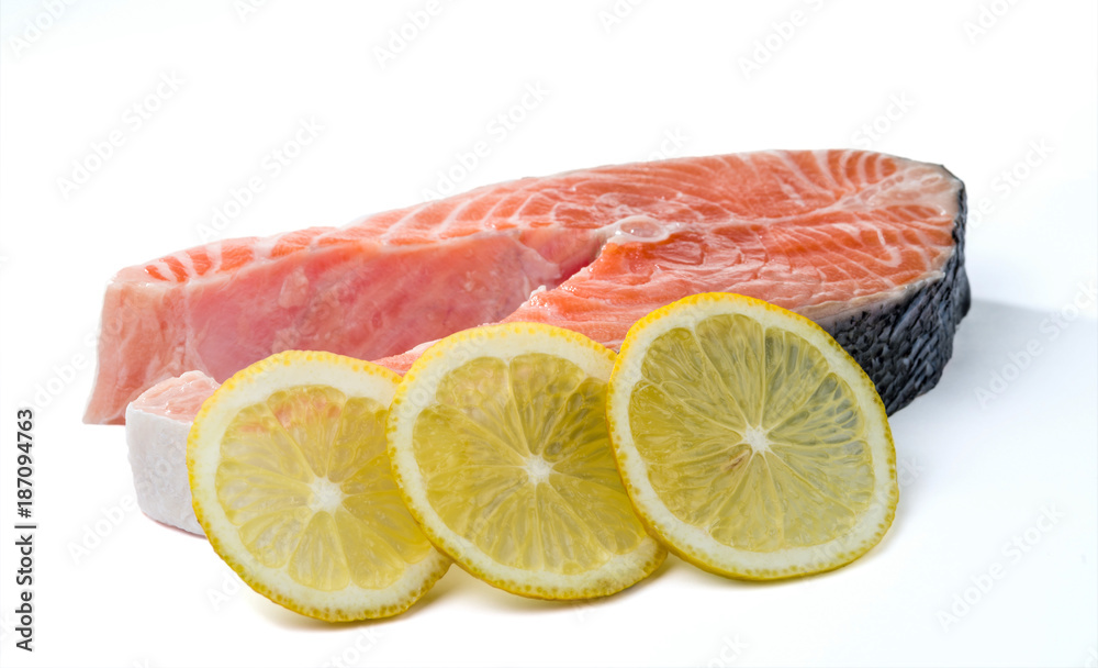 Three circles of lemon and a salmon steak. Selective focus. Three circles of lemon and a salmon steak. Selective focus.