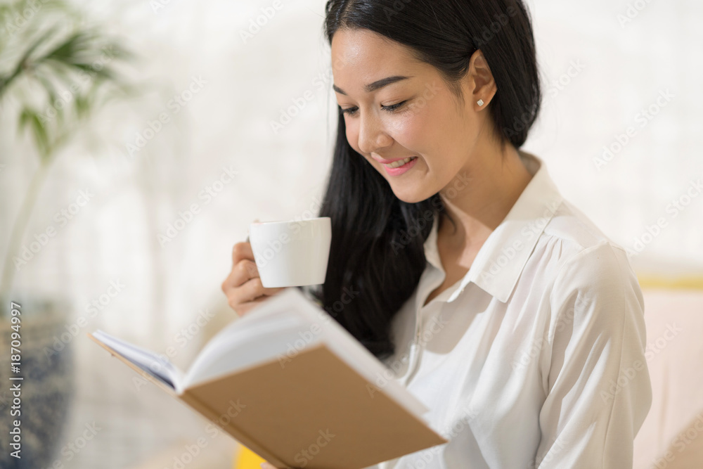 beautiful woman with book in living room beautiful woman with book in living room