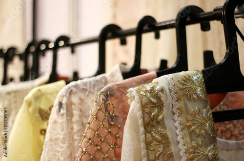 Indian latest fashion clothes hung on hangers in display of a retail shop