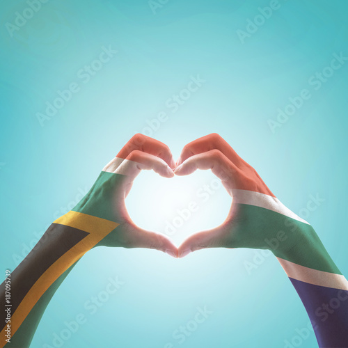 Tableau sur toile South Africa flag on woman hands in heart shape isolated on mint background for national unity, union, love and reconciliation concept