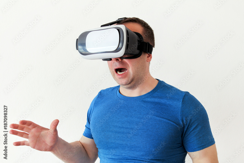 Man wearing and playing mobile game app on device virtual reality glasses  on white background. Man
