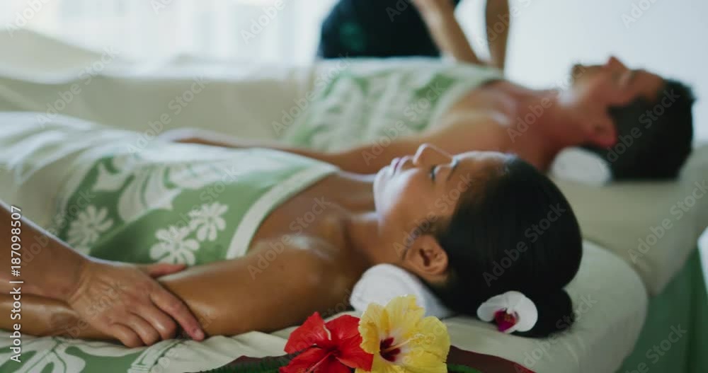 Couple relaxing enjoying massage together at the spa