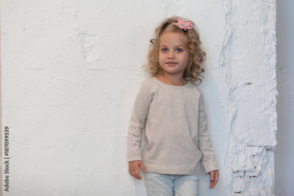 A nice little girl in a gray blank sweatshirt. Mock up. A nice little girl in a gray blank sweatshirt. Mock up.
