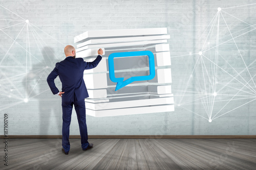 Businessman in front of a wall with 3D rendering Blue Email symbol displayed in a sliced cube