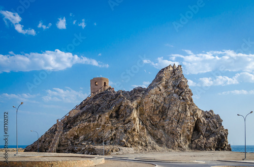 Watchtower over a hill with blue sky.