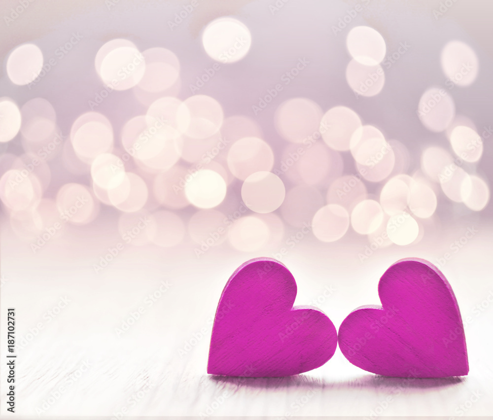Obraz premium Hearts on a wooden table and background is a bokeh.