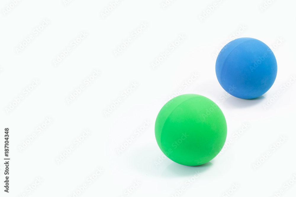 Pet supplies about rubber balls of green and blue for pet on isolated white.