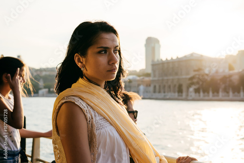 A girl looks at Istanbul at sunset during a tour of bosfor