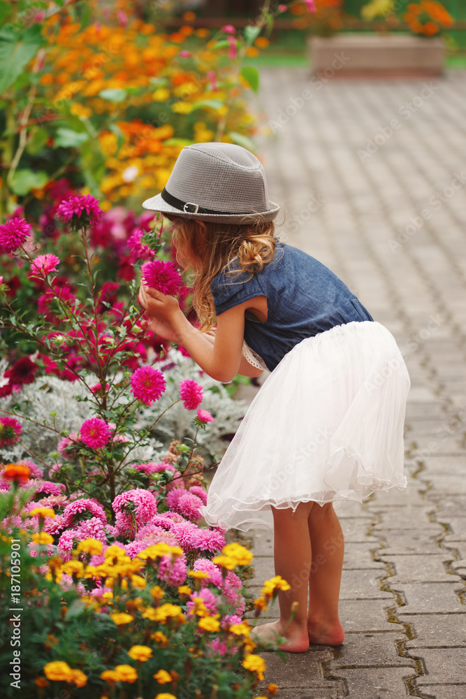 little beautiful girl in flowers park