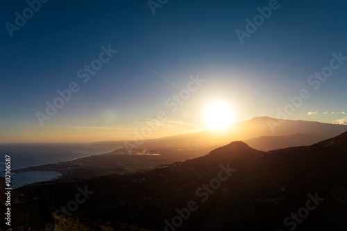 Sunset over the volcano Mount Etna and the gulf of Catania viewed from Taormina, Sicily, Italy, Europe © afinocchiaro