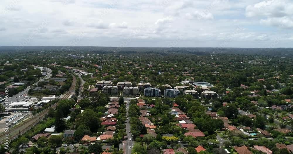 North Shore local suburbs in Sydney from Chatswood to Rovesille over quiet streets and houses facing north in aerial flying forward along city train line.
North Shore local suburbs in Sydney from Chatswood to Rovesille over quiet streets and houses facing north in aerial flying forward along city train line.