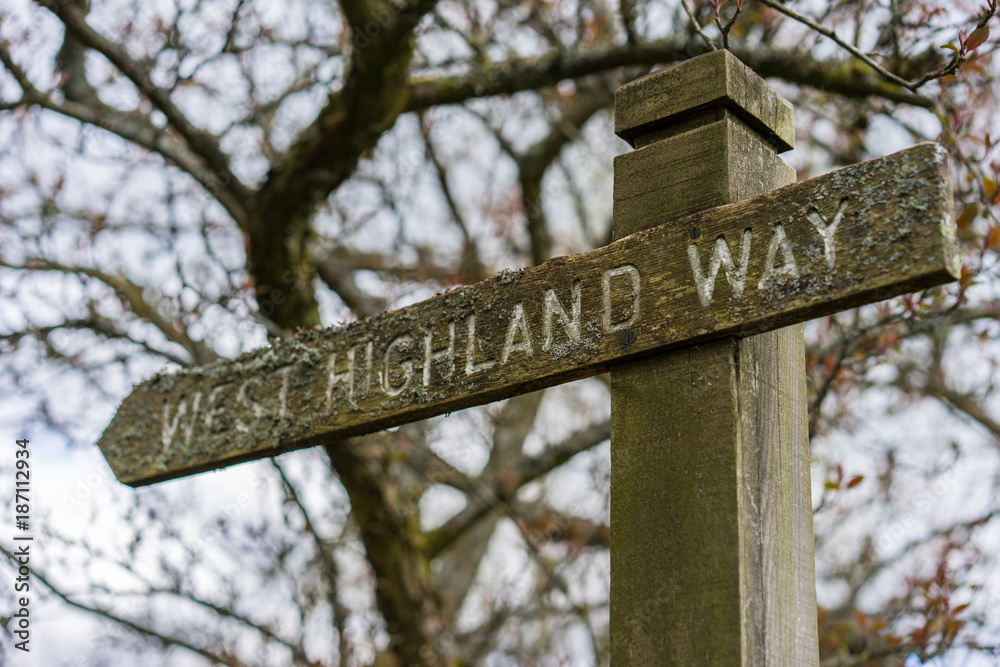 Wooden signpost along the West Highland Way in Scotland