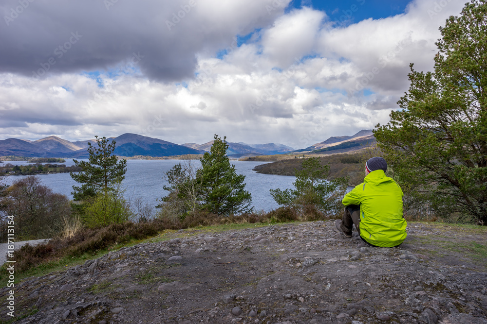 Hiker looking over Loch Lomond in Scotland