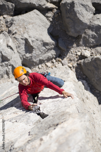 Man makes a big wall climbing in the mountains.
