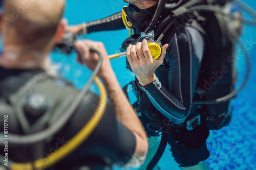 Diving instructor and students. Instructor teaches students to dive photo