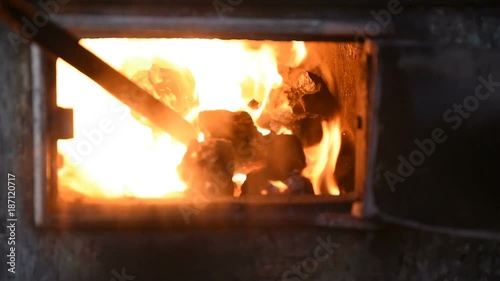 poking with a poker of coal in the furnace