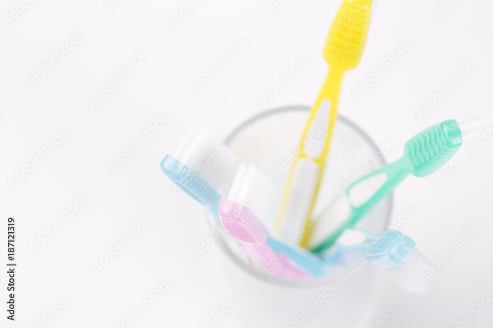 Top view of five toothbrushes in glass - family set of toothbrushes isolated on white background Top view of five toothbrushes in glass - family set of toothbrushes isolated on white background