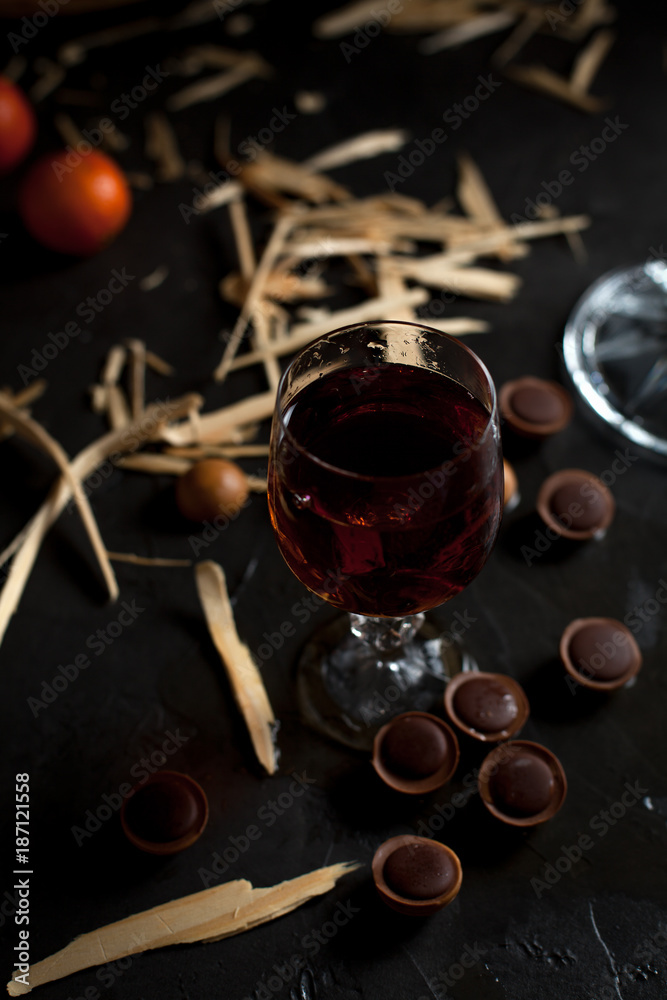 glasses with wine, chocolate and fruit on a dark background glasses with wine, chocolate and fruit on a dark background