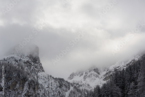 Snowy peaks and mountain ranges and with clouds and mist in winter in Austrian Alps in Stubai