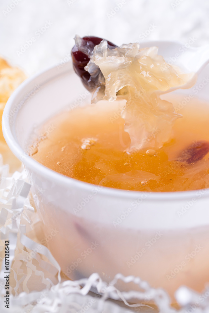Tremella soup. Closeup of tremella and chinese dates in a spoon. Tremella soup. Closeup of tremella and chinese dates in a spoon.