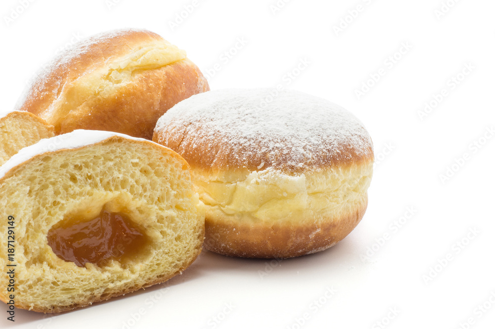 Doughnuts (Sufganiyah) with apricot jam isolated on white background fresh baked with powered sugar.