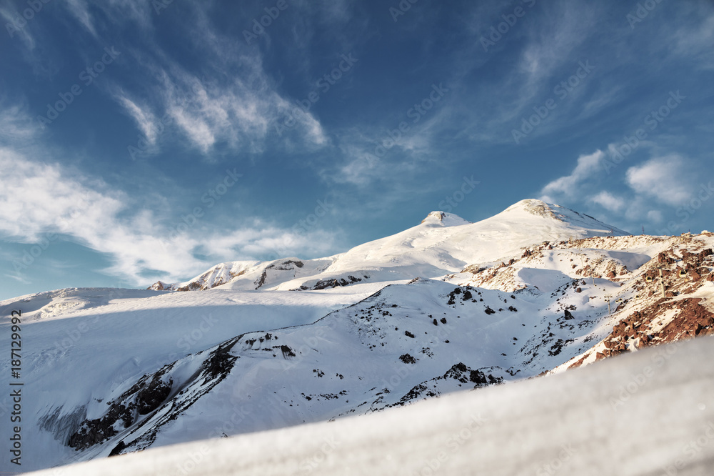 Sleeping snow-capped volcano Elbrus at sunset. North Caucasus. Russia