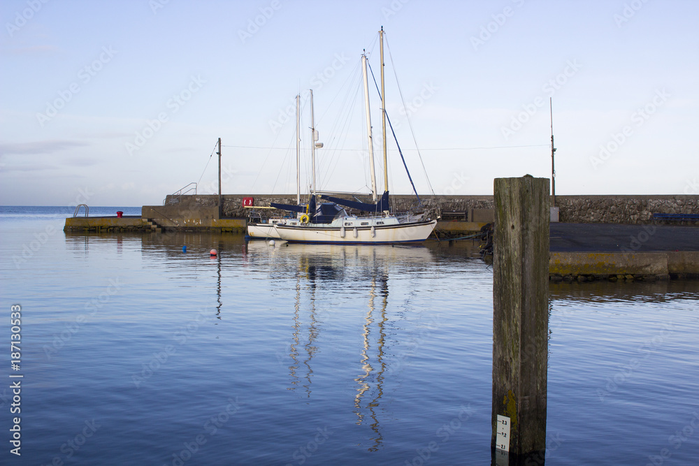 Yachts in the calm waters of Groomsport Harbour in Northern Ireland and pictured in the soft glow of mid winter sunlight Yachts in the calm waters of Groomsport Harbour in Northern Ireland and pictured in the soft glow of mid winter sunlight