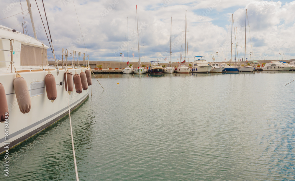 Fototapeta premium the boats anchored at the harbor / detail of a boat anchored with the typical fenders