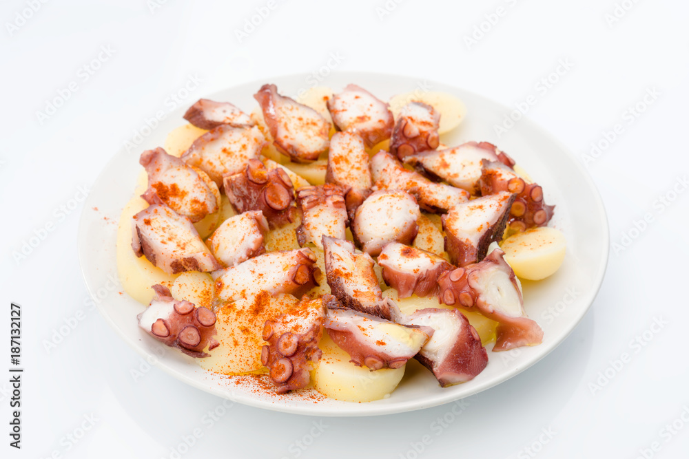 Marinated octopus sliced on potatoes isolated on white Marinated octopus sliced on potatoes isolated on white