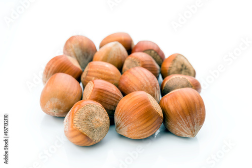 hazelnuts with shell on white background