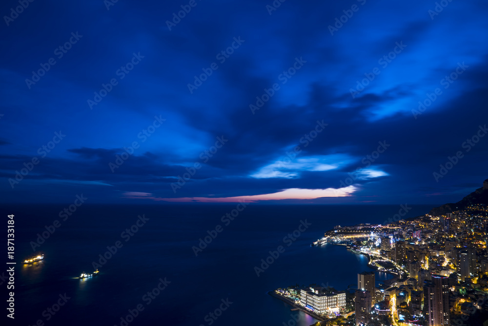 Panoramic view of Monte Carlo in the evening. The Principality of Monaco is situated on a prominent escarpment at the base of the Maritime Alps along the French Riviera.