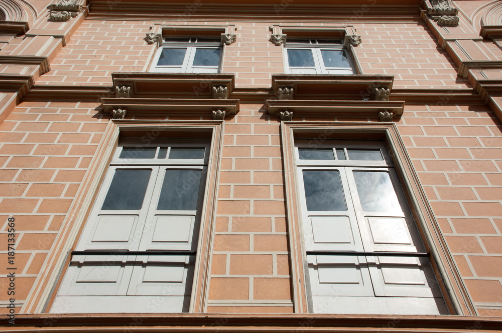 neocolonial facade of a historical building with big windows in a antizenital angle