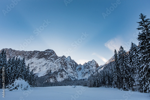 Mangart mountain range seen from snow covert frozen lake Fusine © photoflorenzo