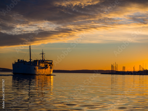 Big passanger ship sailing into the sunset. © photoanto