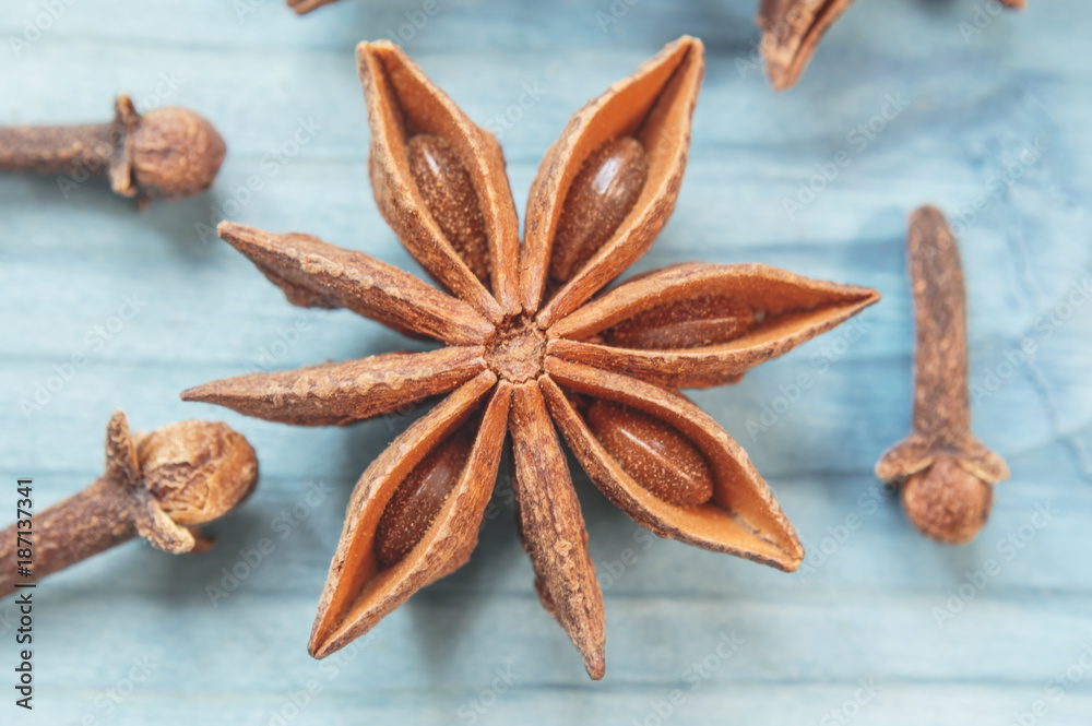 Star anise, cinnamon sticks and cloves on a nintage background. Star anise, cinnamon sticks and cloves on a nintage background.