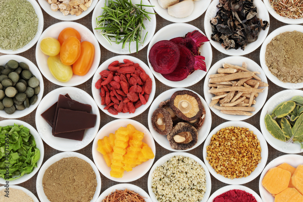 Brain boosting health food selection with fruit, vegetables, bee grain pollen, seeds, dark chocolate, supplement powders with herbs also used in herbal medicine.