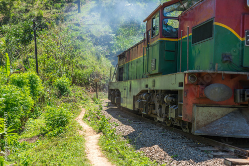 Shortly behind the nine arches bridge between Demodara and Ella, the track leads through a tunnel. The locomotive is on the way to Ella, in the highlands of Sri Lanka