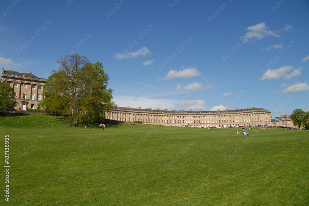 People relaxing on the lawn in front of The Royal Crescent, Bath, United Kingdom